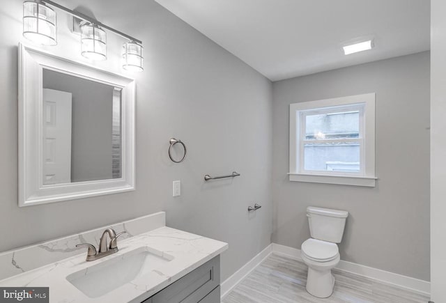 1309 S 52nd St, Philadelphia, PA 19143 - bathroom with baseboards, vanity, toilet, and wood finished floors