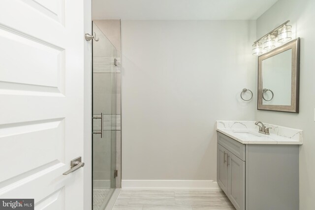 1309 S 52nd St, Philadelphia, PA 19143 - bathroom featuring a stall shower, vanity, baseboards, and marble look tiles
