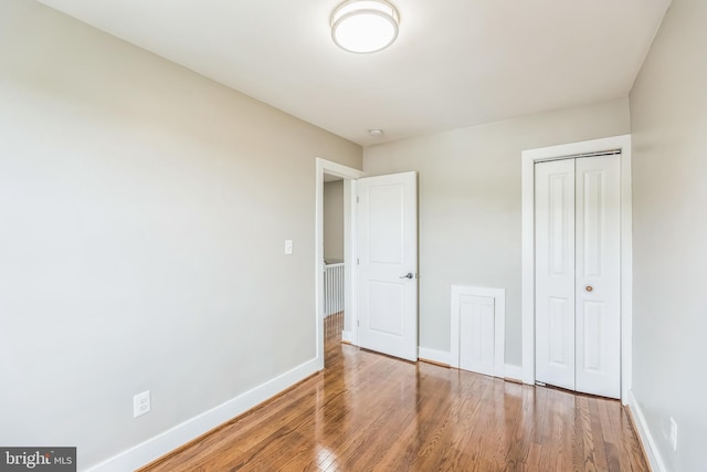 1778 Lang Pl NE, Washington, DC 20002 - unfurnished bedroom with wood finished floors, baseboards, and a closet