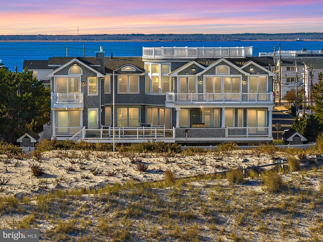6601 Ocean Blvd, Long Beach Township, NJ 08008 - back of house with a balcony and a water view