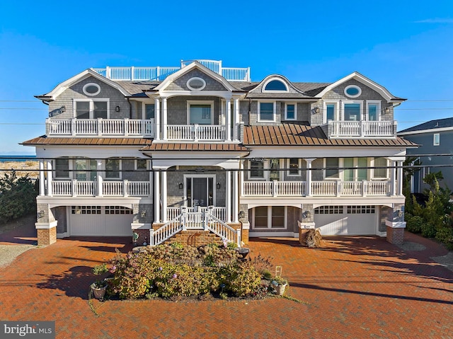 6601 Ocean Blvd, Long Beach Township, NJ 08008 - view of front facade with a garage, decorative driveway, and a balcony
