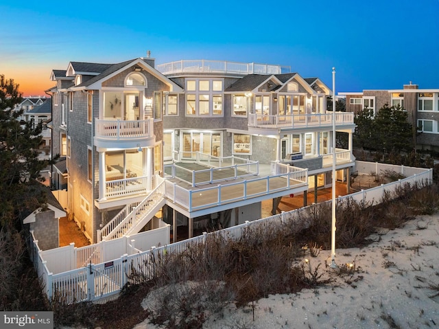 6601 Ocean Blvd, Long Beach Township, NJ 08008 - rear view of house with a balcony and a fenced backyard