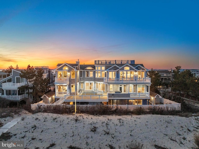 6601 Ocean Blvd, Long Beach Township, NJ 08008 - back of property at dusk with a balcony and a chimney