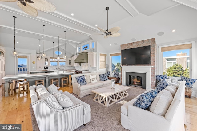6601 Ocean Blvd, Long Beach Township, NJ 08008 - living room featuring ceiling fan, a fireplace, beam ceiling, light wood-style flooring, and recessed lighting