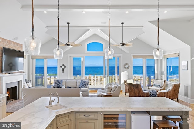 6601 Ocean Blvd, Long Beach Township, NJ 08008 - kitchen featuring a ceiling fan, wine cooler, a sink, open floor plan, and high vaulted ceiling