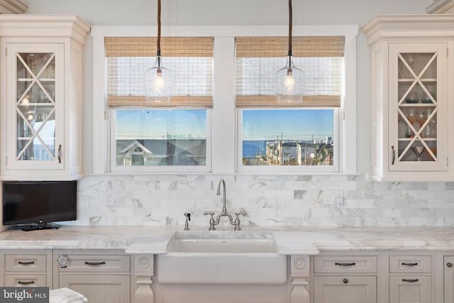 6601 Ocean Blvd, Long Beach Township, NJ 08008 - kitchen with a sink, decorative backsplash, glass insert cabinets, and pendant lighting