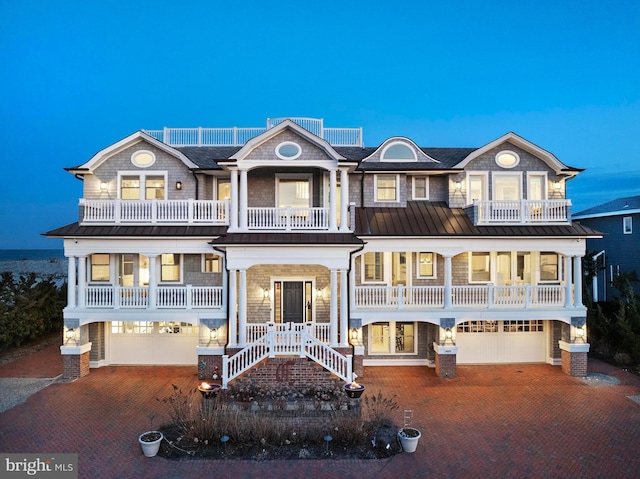 6601 Ocean Blvd, Long Beach Township, NJ 08008 - view of front of property with a balcony, an attached garage, decorative driveway, and a standing seam roof