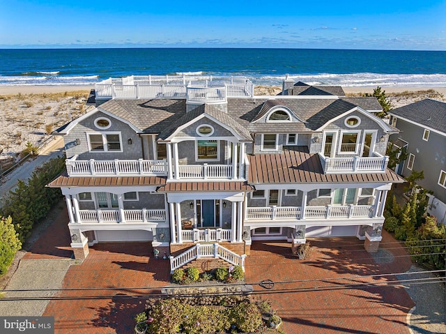 6601 Ocean Blvd, Long Beach Township, NJ 08008 - view of front facade with a standing seam roof, metal roof, view of water and beach, and a balcony