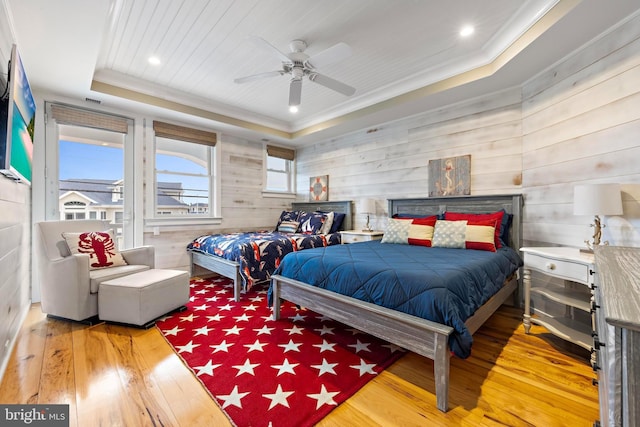 6601 Ocean Blvd, Long Beach Township, NJ 08008 - bedroom featuring hardwood / wood-style floors, crown molding, a raised ceiling, wood walls, and a ceiling fan