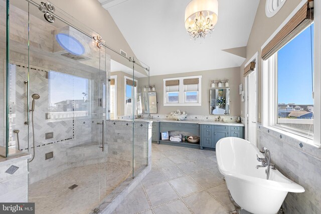 6601 Ocean Blvd, Long Beach Township, NJ 08008 - bathroom featuring lofted ceiling, a stall shower, a freestanding bath, vanity, and a chandelier