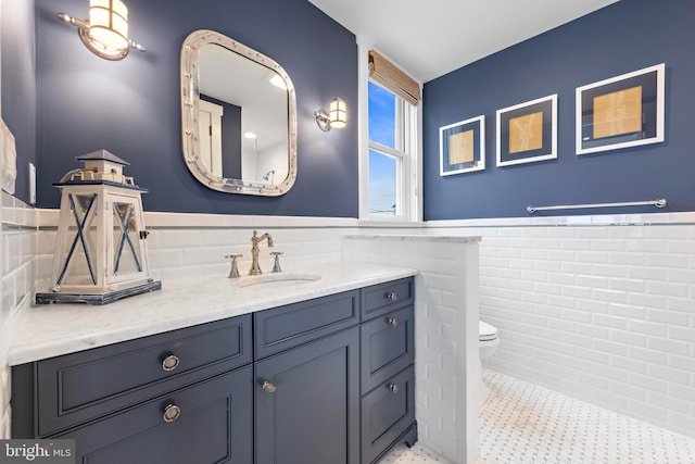 6601 Ocean Blvd, Long Beach Township, NJ 08008 - bathroom with tile walls, wainscoting, toilet, and vanity