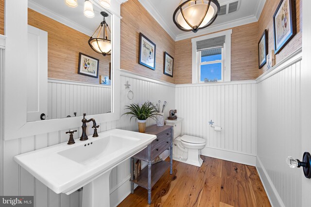 6601 Ocean Blvd, Long Beach Township, NJ 08008 - half bath with toilet, wainscoting, wood finished floors, and crown molding