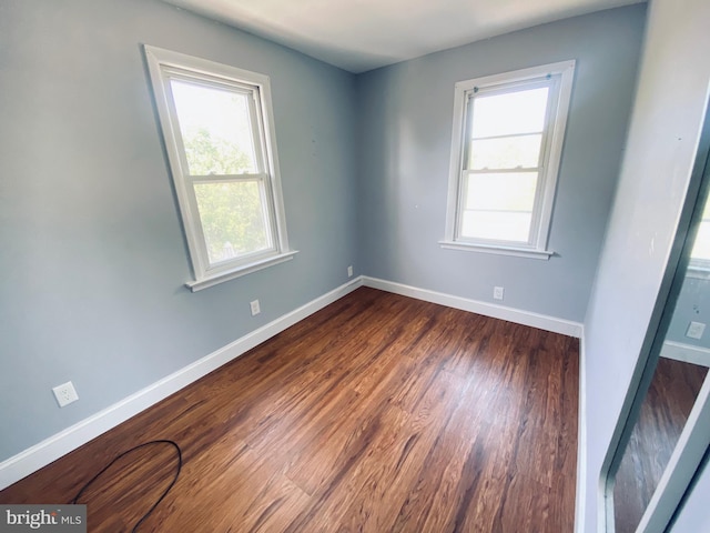 976 Klockner Rd, Hamilton Township, NJ 08619 - spare room with healthy amount of natural light, baseboards, and dark wood-type flooring