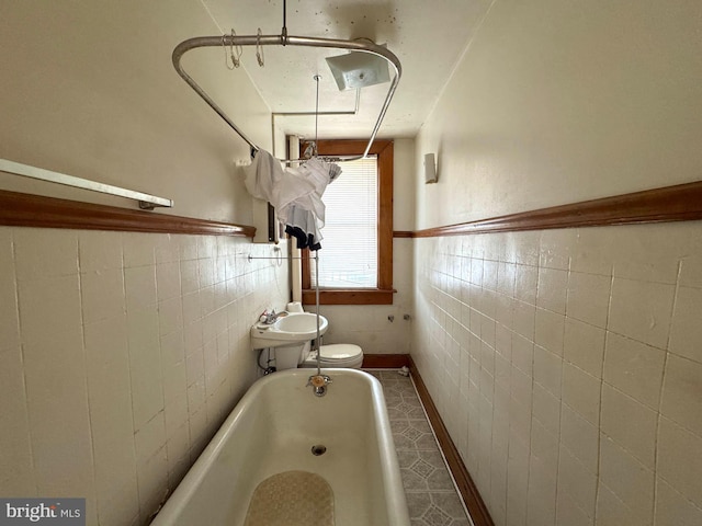 1332 Sargeant St, Baltimore, MD 21223 - full bathroom featuring tile walls, a bathtub, a wainscoted wall, a sink, and toilet