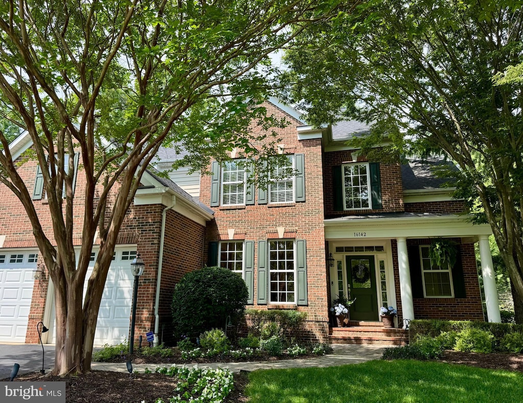16142 Jordan Crest Ct, Haymarket, VA 20169 - view of front facade featuring brick siding, an attached garage, and driveway