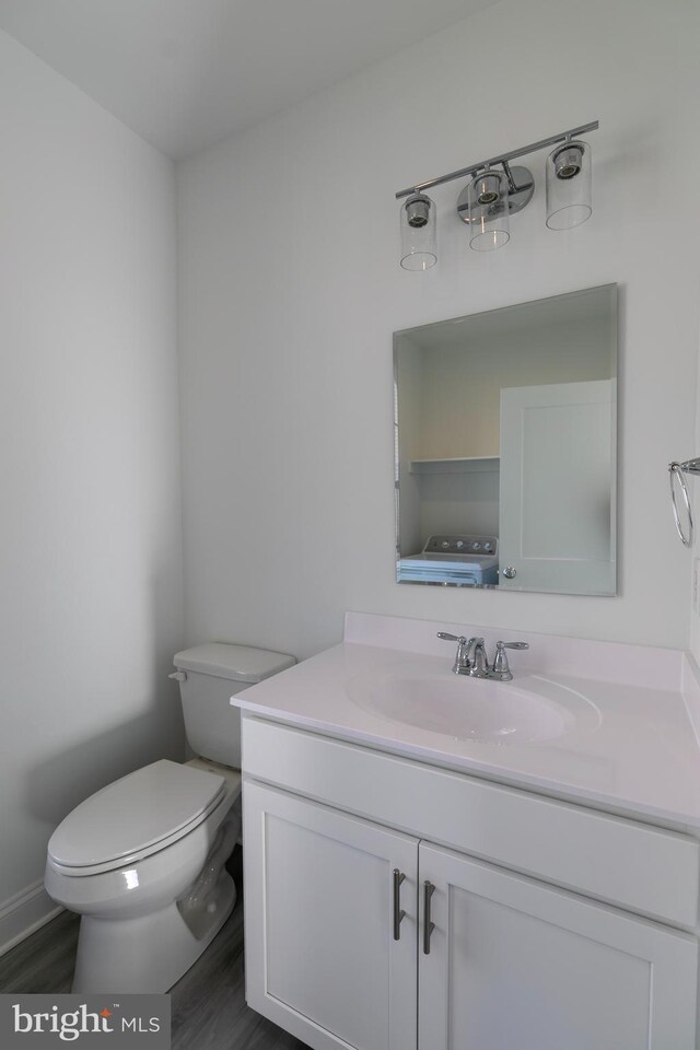 93 6th St W, Laurel, DE 19956 - bathroom with toilet, vanity, and wood finished floors