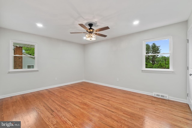 spare room featuring light wood-style floors, a ceiling fan, baseboards, and recessed lighting