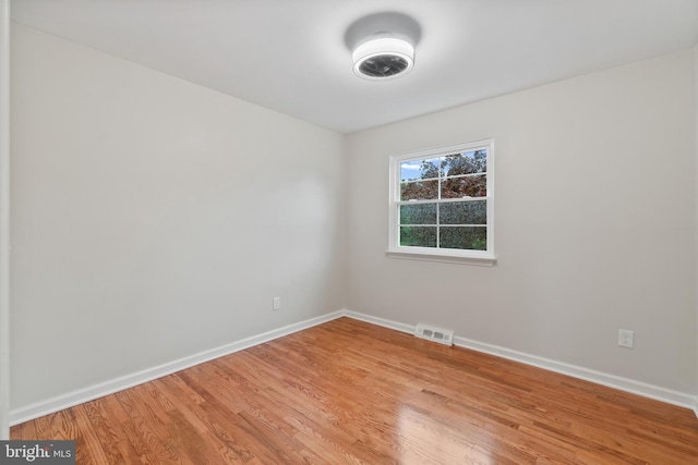 unfurnished room featuring light wood-style flooring and baseboards