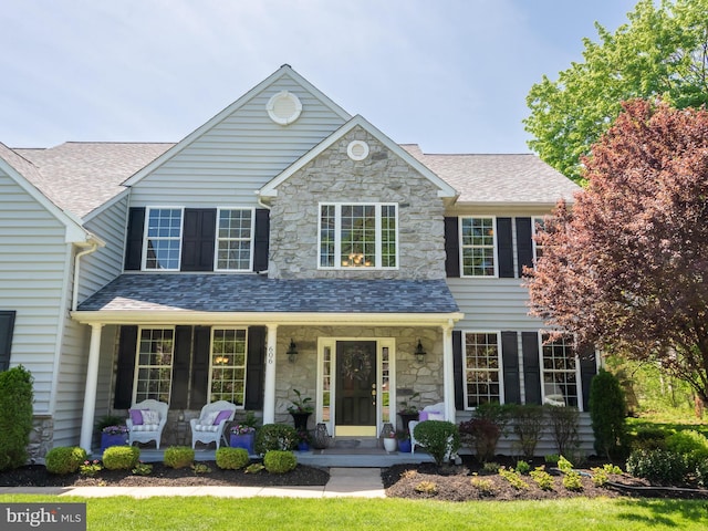 606 Borough Line Rd, Collegeville, PA 19426 - view of front facade with a porch, stone siding, and roof with shingles
