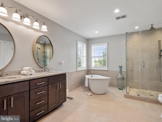 606 Borough Line Rd, Collegeville, PA 19426 - bathroom with a stall shower, double vanity, tile walls, tile patterned flooring, and a soaking tub