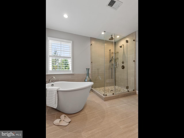 606 Borough Line Rd, Collegeville, PA 19426 - bathroom featuring a shower stall, a freestanding tub, and recessed lighting