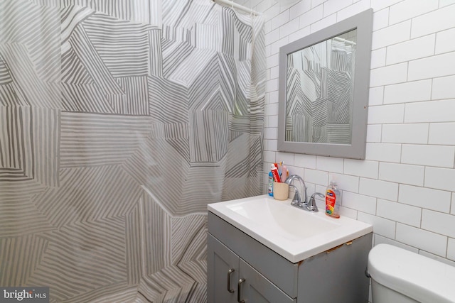 4504 Vista St, Philadelphia, PA 19136 - bathroom with tile walls, toilet, vanity, and backsplash