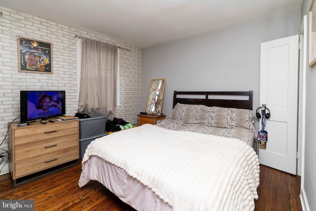 4504 Vista St, Philadelphia, PA 19136 - bedroom with dark wood finished floors and brick wall