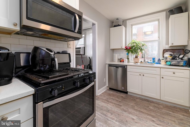 4504 Vista St, Philadelphia, PA 19136 - kitchen featuring stainless steel appliances, a sink, tasteful backsplash, and healthy amount of natural light