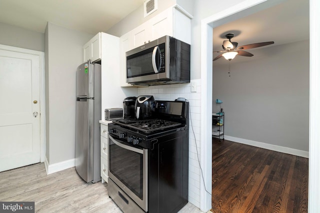 4504 Vista St, Philadelphia, PA 19136 - kitchen featuring appliances with stainless steel finishes, light wood-type flooring, white cabinets, and a ceiling fan