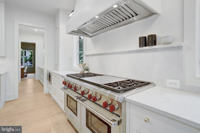 1416 N Hancock St, Arlington, VA 22201 - kitchen featuring range with two ovens, premium range hood, white cabinetry, light wood-style flooring, and light stone countertops