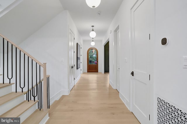 1416 N Hancock St, Arlington, VA 22201 - corridor featuring light wood finished floors, stairway, and baseboards