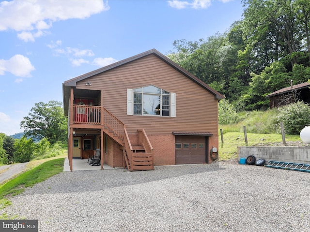 18421 Lower Georges Creek Rd SW, Barton, MD 21521 - view of front of house featuring gravel driveway, stairs, an attached garage, and brick siding