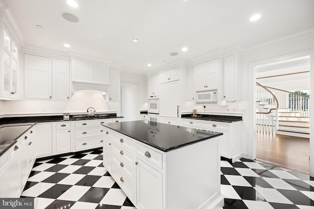 17 Revell St, Annapolis, MD 21401 - kitchen featuring dark floors, dark countertops, white cabinetry, recessed lighting, and crown molding
