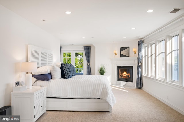 17 Revell St, Annapolis, MD 21401 - bedroom with a glass covered fireplace, light carpet, recessed lighting, and french doors