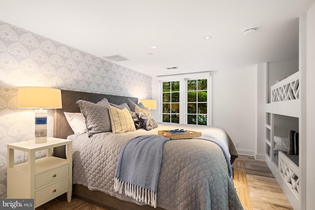 17 Revell St, Annapolis, MD 21401 - bedroom featuring wallpapered walls, an accent wall, wood finished floors, and recessed lighting