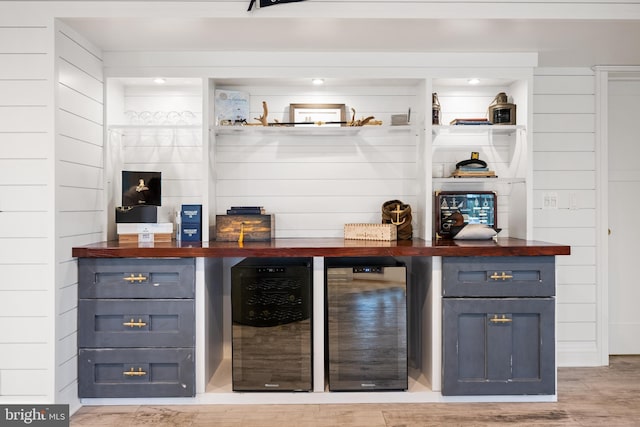17 Revell St, Annapolis, MD 21401 - bar featuring beverage cooler, light wood-style floors, and wooden walls