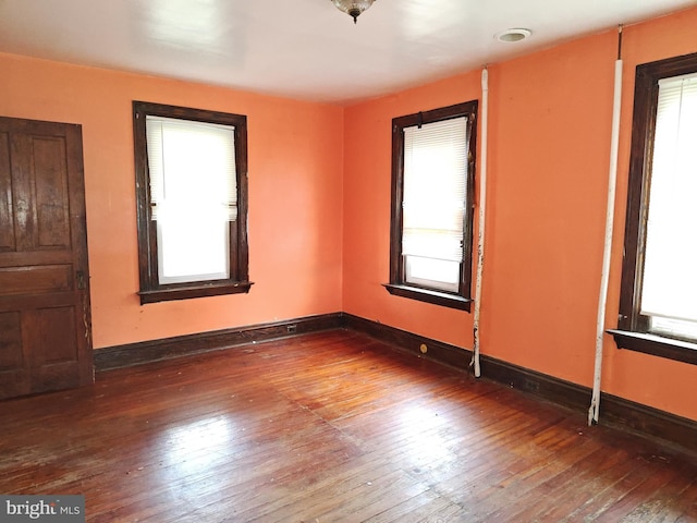 empty room featuring hardwood / wood-style floors and baseboards