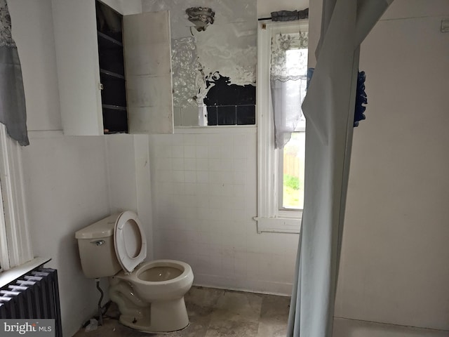 bathroom featuring radiator and toilet