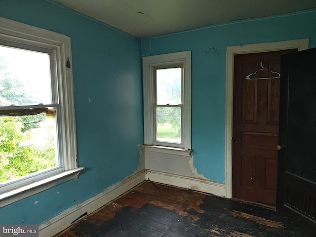 spare room with hardwood / wood-style flooring and baseboards