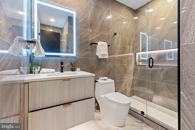 310 Varnum St NW Unit 3Ph, Washington, DC 20011 - full bathroom featuring tile walls, marble tiled floors, toilet, a stall shower, and vanity