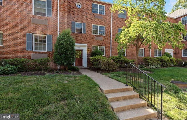1716 W Abingdon Dr Unit 103, Alexandria, VA 22314 - view of front of home with a front yard and brick siding