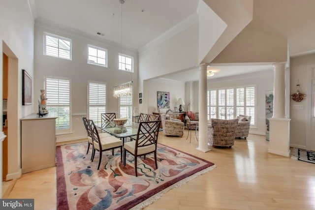 13605 Autumn End Ter, Laurel, MD 20707 - dining room with ornate columns, crown molding, light wood finished floors, baseboards, and a high ceiling