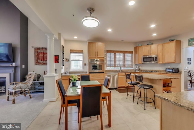 13605 Autumn End Ter, Laurel, MD 20707 - dining space featuring decorative columns, recessed lighting, light carpet, light tile patterned floors, and a glass covered fireplace