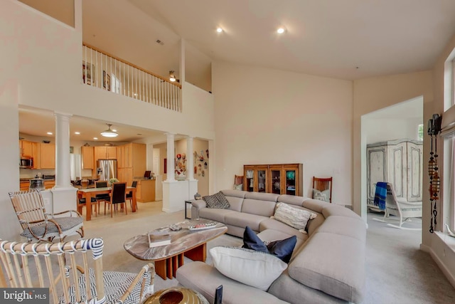 13605 Autumn End Ter, Laurel, MD 20707 - living area featuring ornate columns, light colored carpet, a high ceiling, and recessed lighting