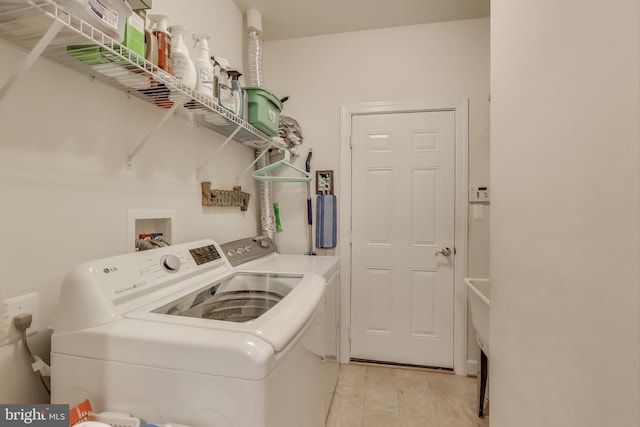 13605 Autumn End Ter, Laurel, MD 20707 - laundry area featuring washing machine and clothes dryer and light tile patterned floors