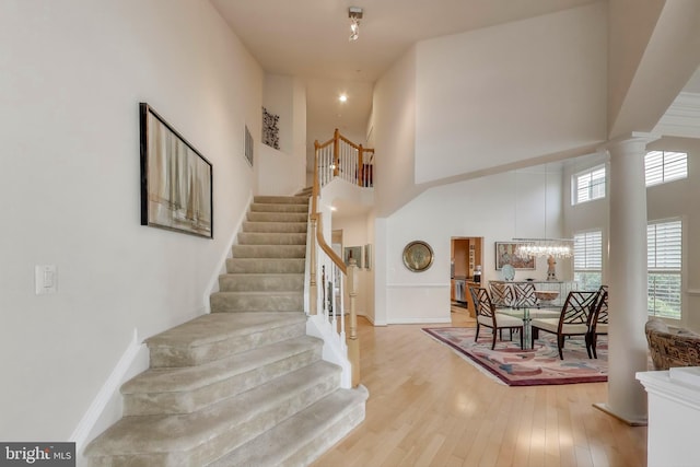 13605 Autumn End Ter, Laurel, MD 20707 - stairway with healthy amount of natural light, a high ceiling, wood finished floors, ornate columns, and baseboards