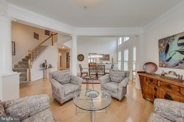 13605 Autumn End Ter, Laurel, MD 20707 - living room with decorative columns, ornamental molding, wood finished floors, a chandelier, and stairway