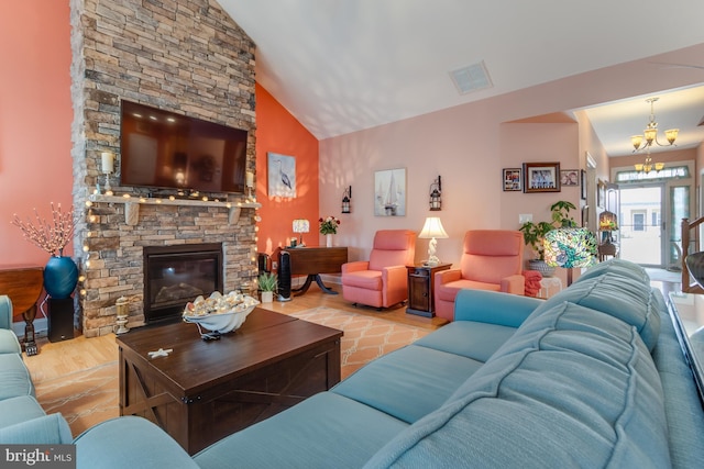 15149 Coultlands Reach, Milton, DE 19968 - living area featuring a stone fireplace, wood finished floors, a chandelier, and high vaulted ceiling