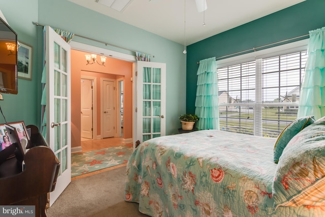 15149 Coultlands Reach, Milton, DE 19968 - carpeted bedroom featuring french doors and a chandelier