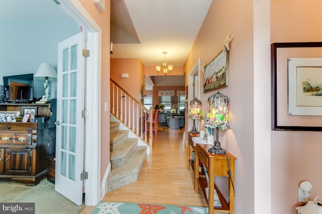 15149 Coultlands Reach, Milton, DE 19968 - foyer entrance featuring a chandelier, stairs, wood finished floors, and french doors